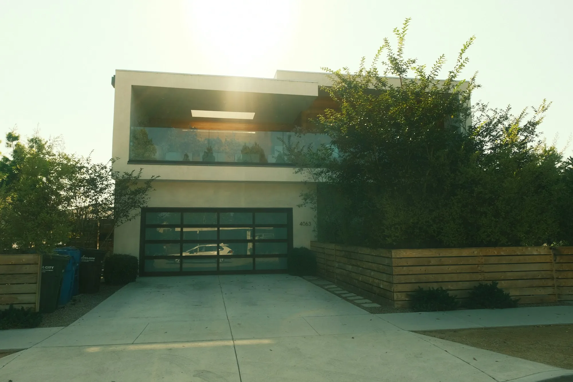 Modern home with a wide concrete driveway leading to the garage