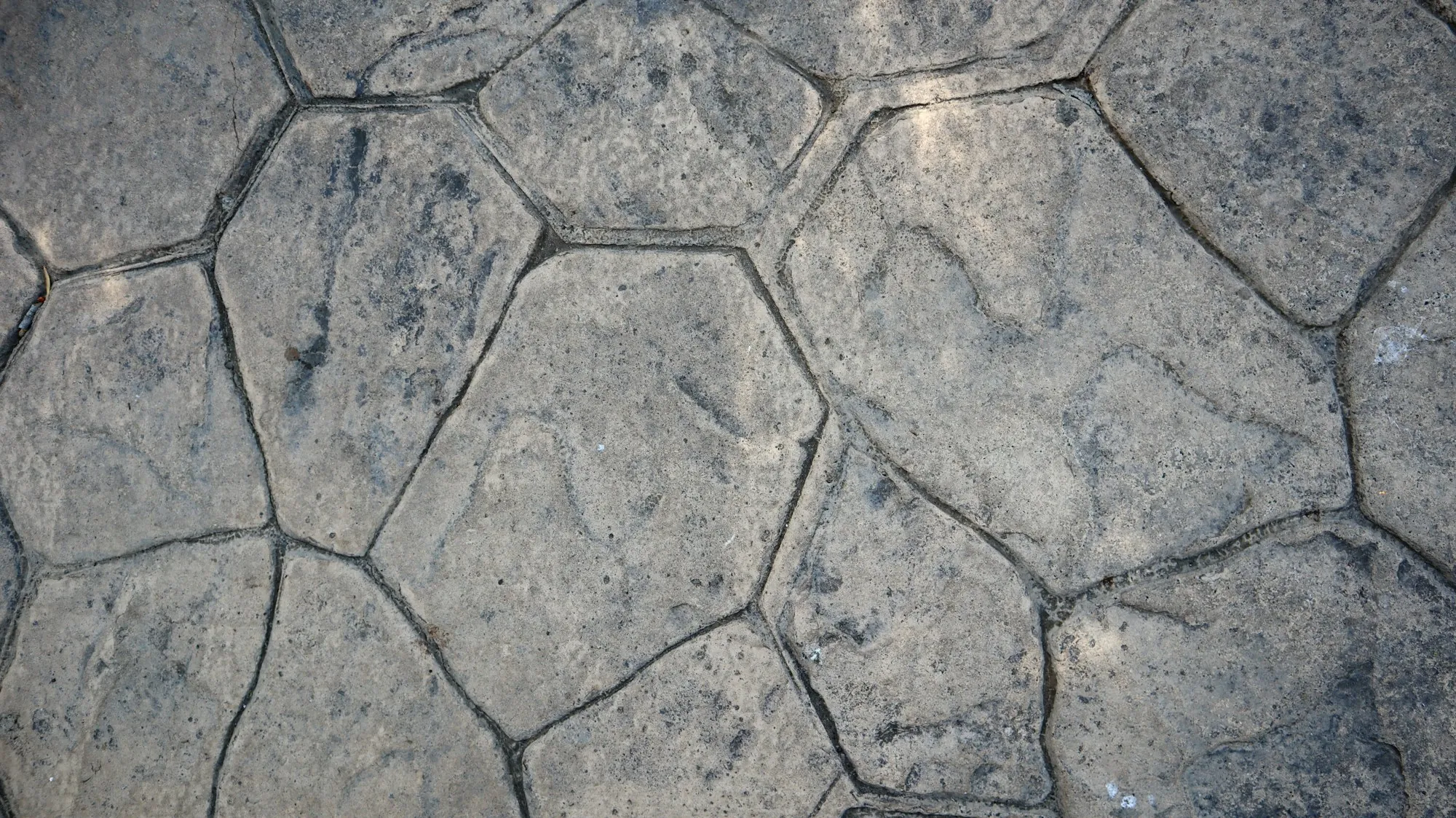 Gray stamped concrete in a random stone pattern